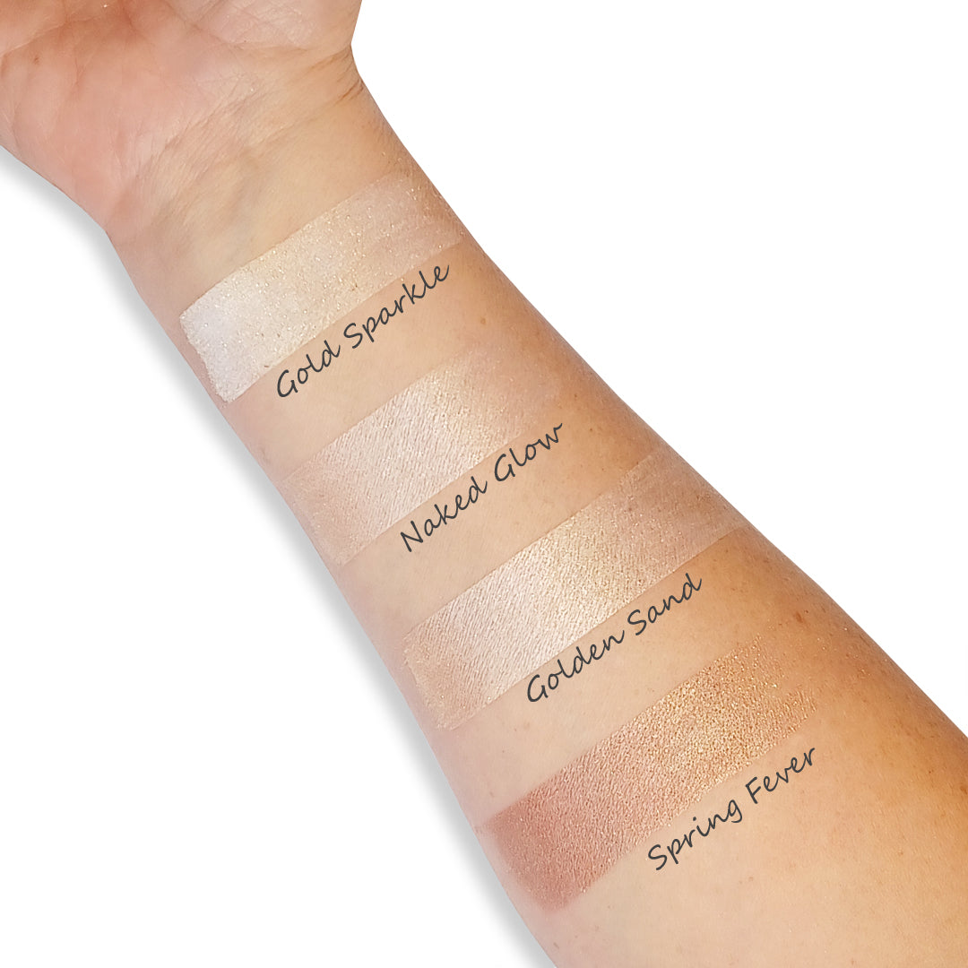 Swatches of different makeup shades on a person's arm with color names.