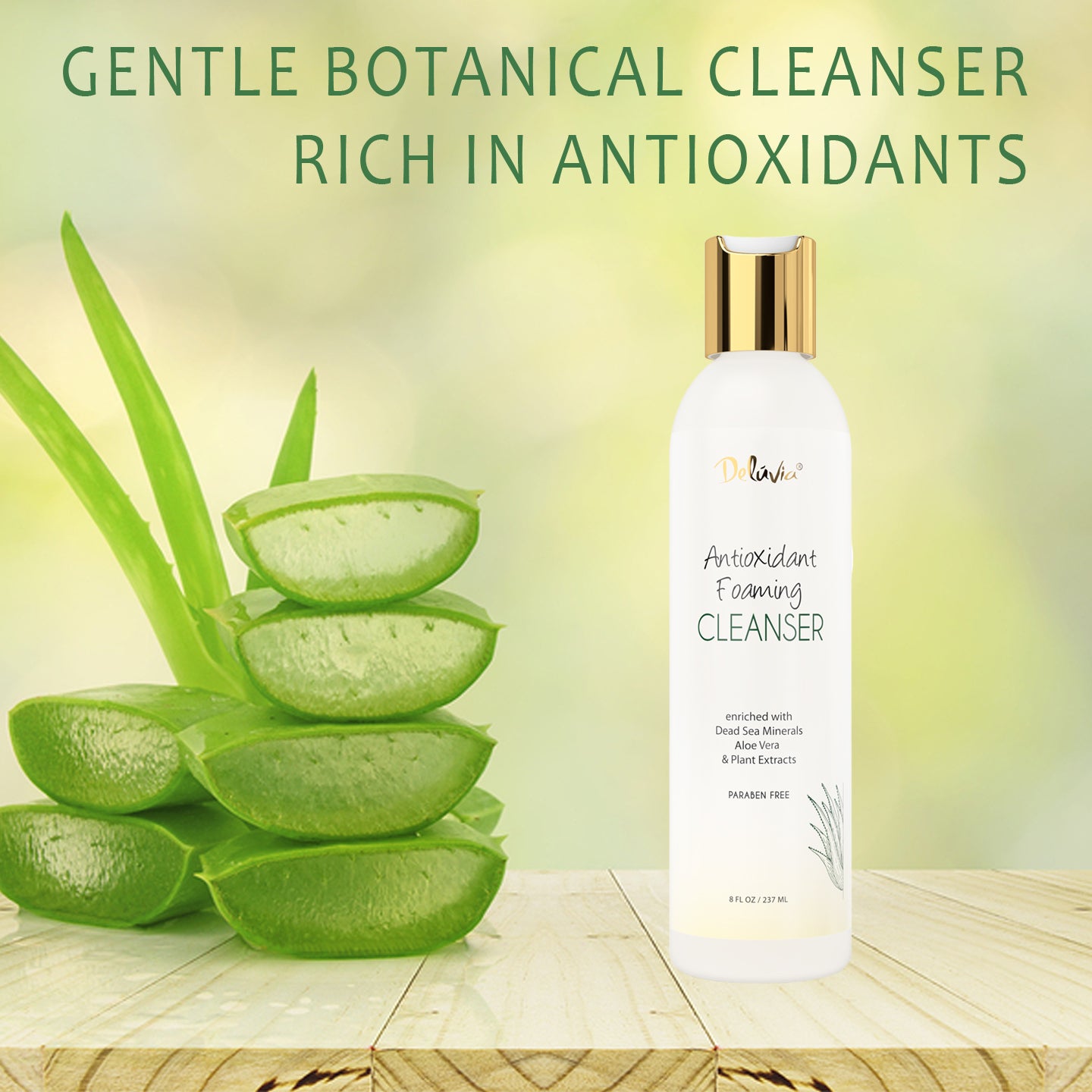 Photocomposition of a bottle of Deluvia's Antioxidant Foaming Cleanser set on a raw wood table with cut leaves of aloe vera