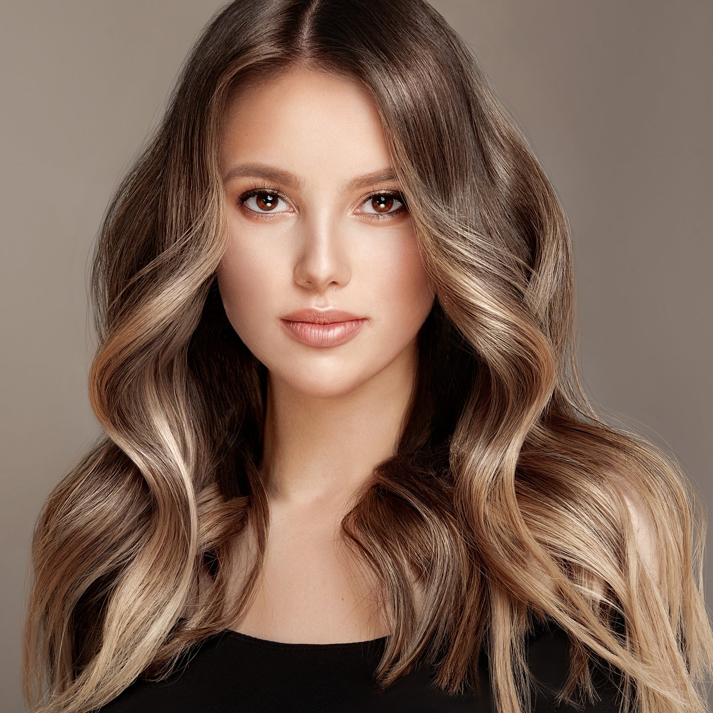 A woman with long, silky hair, with gentle waves.