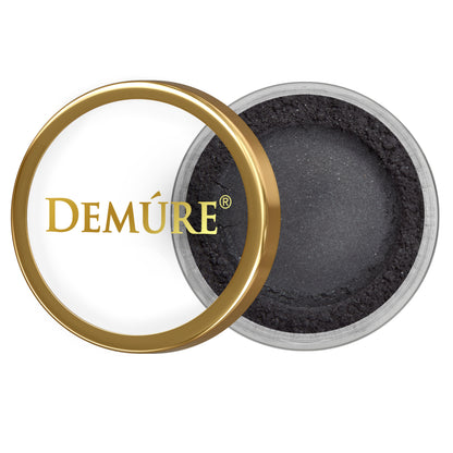 Open container of Demure Black Liner eye color with gold lid on a white background