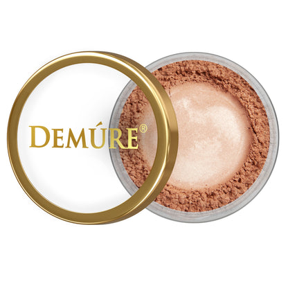 Open container of Demure Bronze Peach eye color with gold lid on a white background