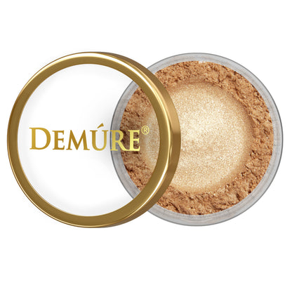 Open container of Demure Gold Shimmer eye color with gold lid on a white background