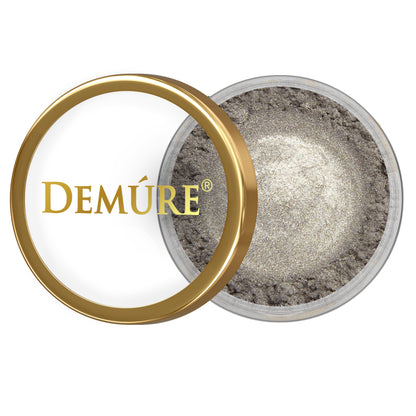 Open container of Demure Pewter eye color with gold lid on a white background