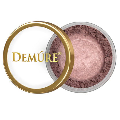 Open container of Demure Plum eye color with gold lid on a white background