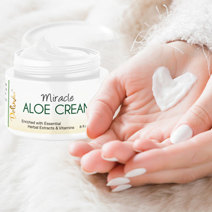 A jar of Deluvia Miracle Aloe Cream with a woman's hand with a smear of cream in the shape of a heart