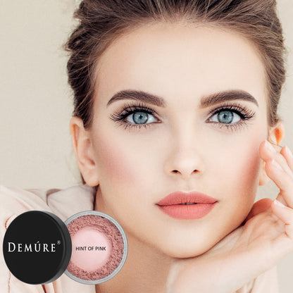 Woman wearing Demure Hint of Pink Blush with jar in the foreground