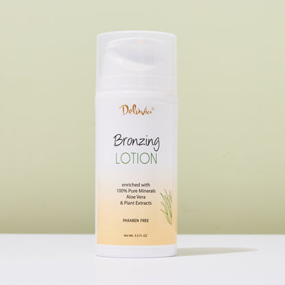 Deluvia Bronzing Lotion bottle on a white surface with a light green background