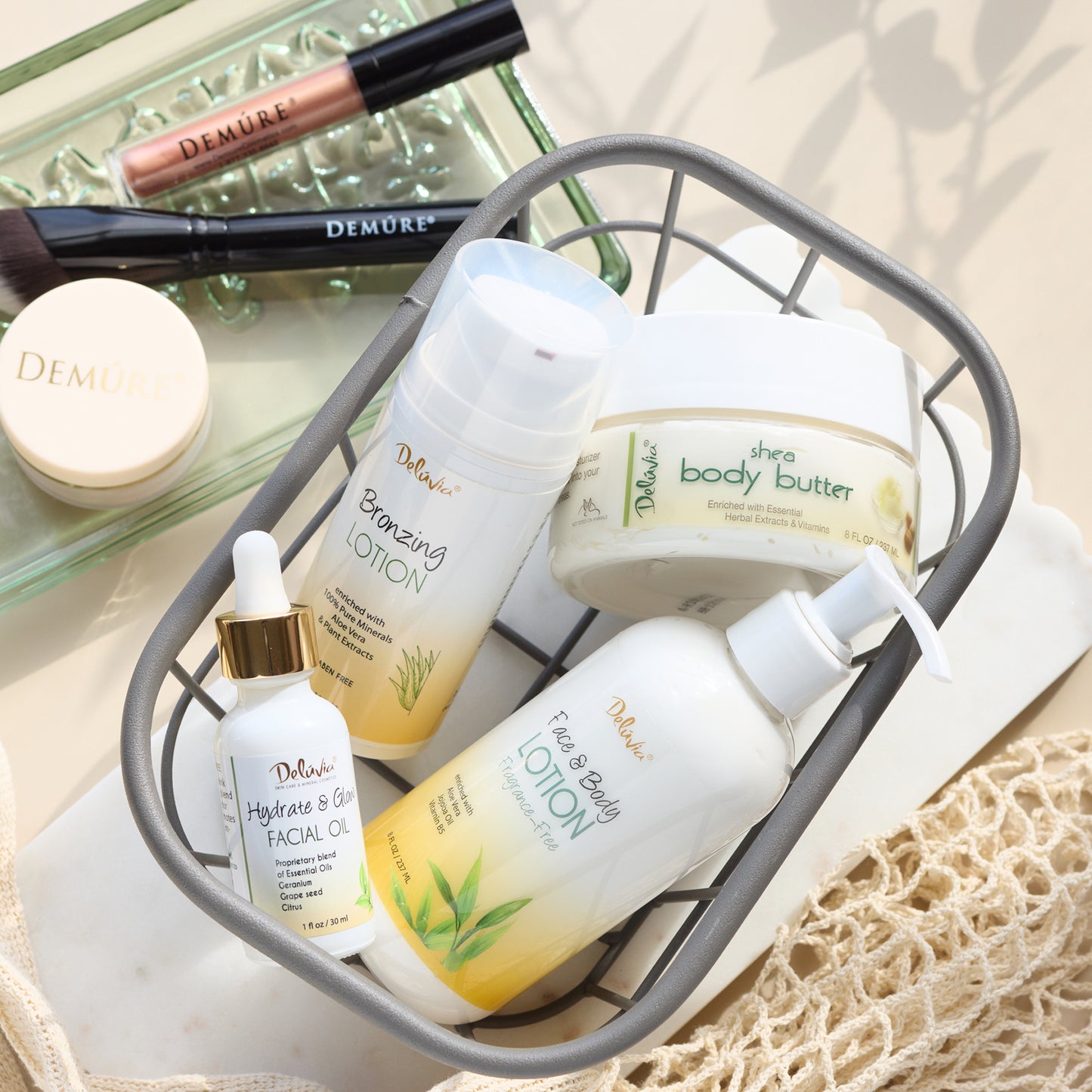 A basket of Deluvia skincare products including Hydrate & Glow Facial Oil, Face & Body Lotions, Bronzing Lotion, and Shea Body Butter