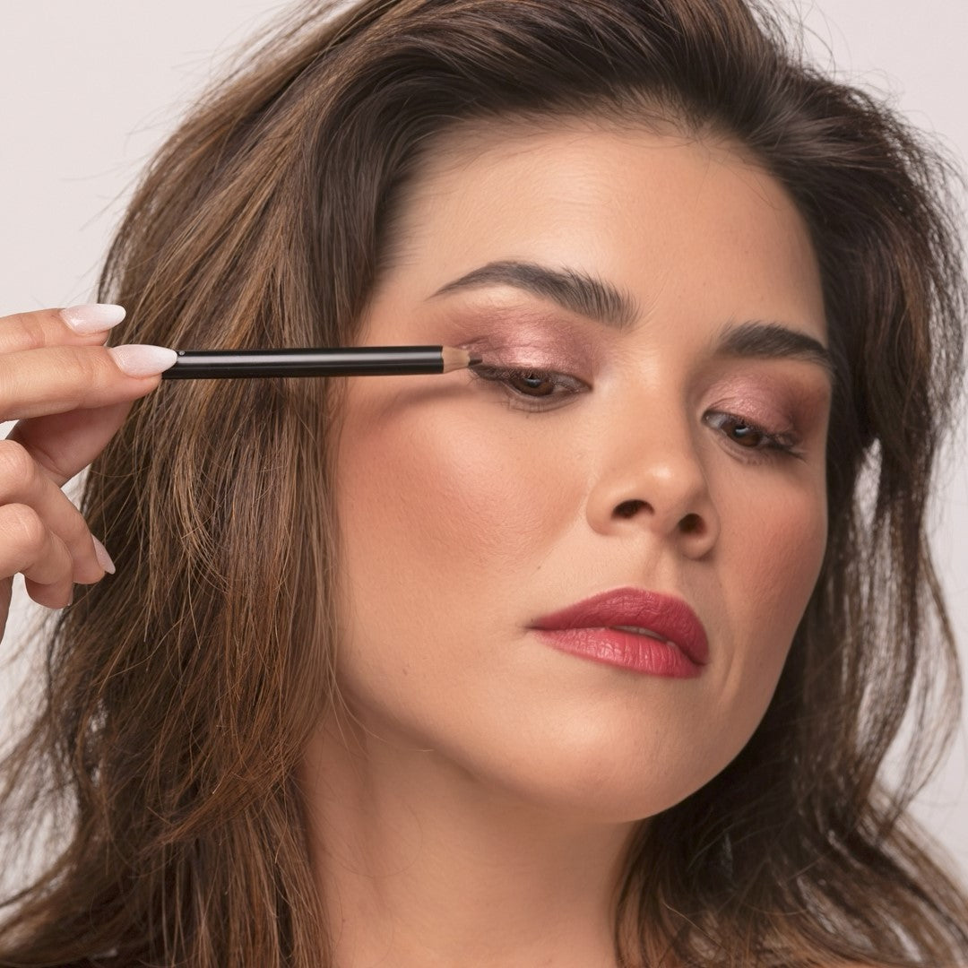 Woman applying Demure Dark Brown Eye Liner