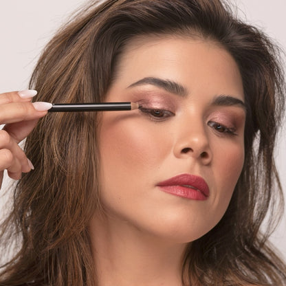 Woman applying Demure Dark Brown Eye Liner
