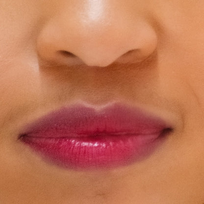 Close up of a woman's lips wearing Demure Lipstick Deep Wine.