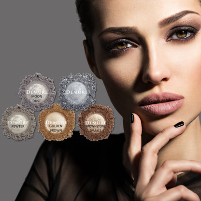 Woman wearing eye makeup with six Demure silver shimmer eye colors in the foreground