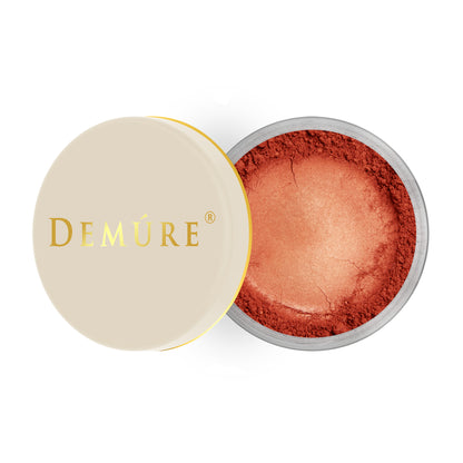 Open container of Demure Brick color loose blush with a gold lid