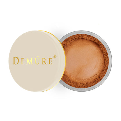 Open container of Demure Cinnamon color loose blush with a gold lid