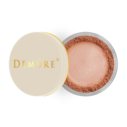 Open container of Demure Mocha Rose color loose blush with a gold lid