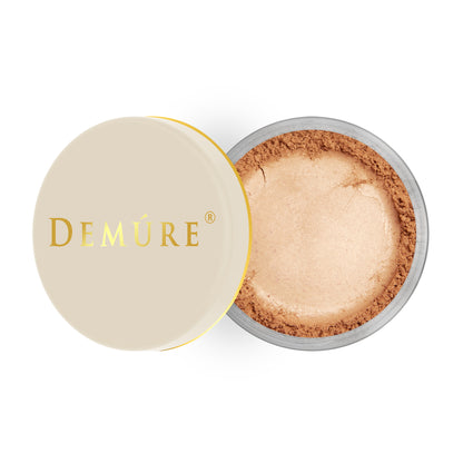 Open container of Demure Peachy color loose blush with a gold lid