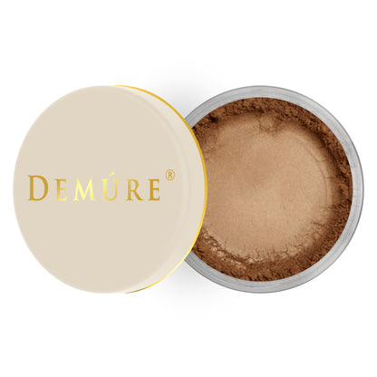 Open container of Demure  Cappuccino color loose foundation with a gold lid