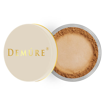 Open container of Demure Dark color loose finishing with a gold lid