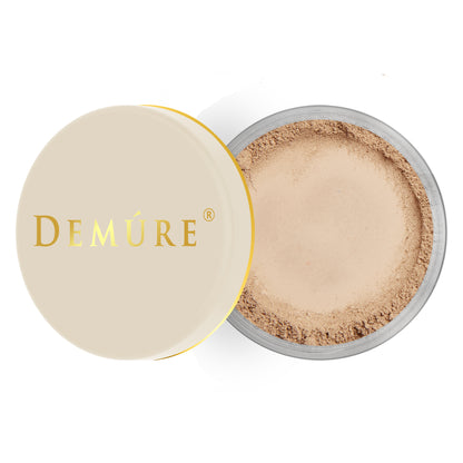 Open container of Demure Medium Dark  color loose foundation with a gold lid