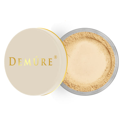 Open container of Demure Medium Warm color loose foundation with a gold lid