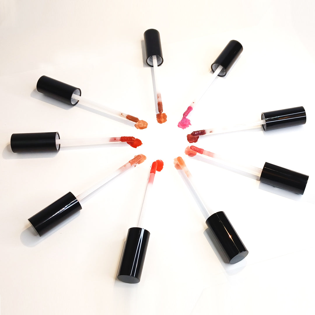 Lip gloss applicators in a circle showing color swatches of each