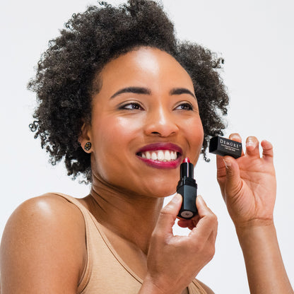 African American woman wearing Demure Deep Wine Lipstick