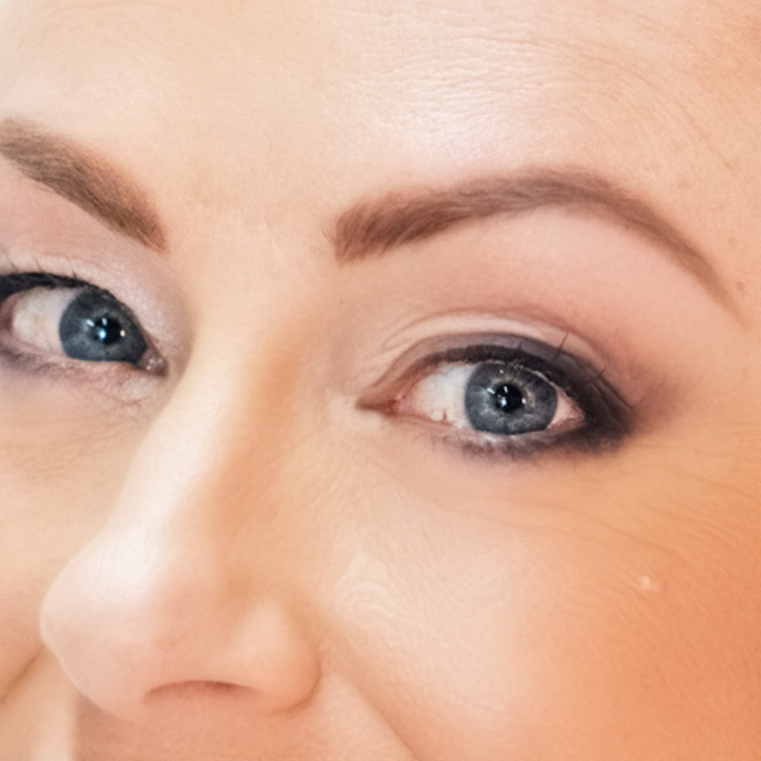 Close-up of one side of woman's face with a wearing Demure Eye Brow Liner in Taupe