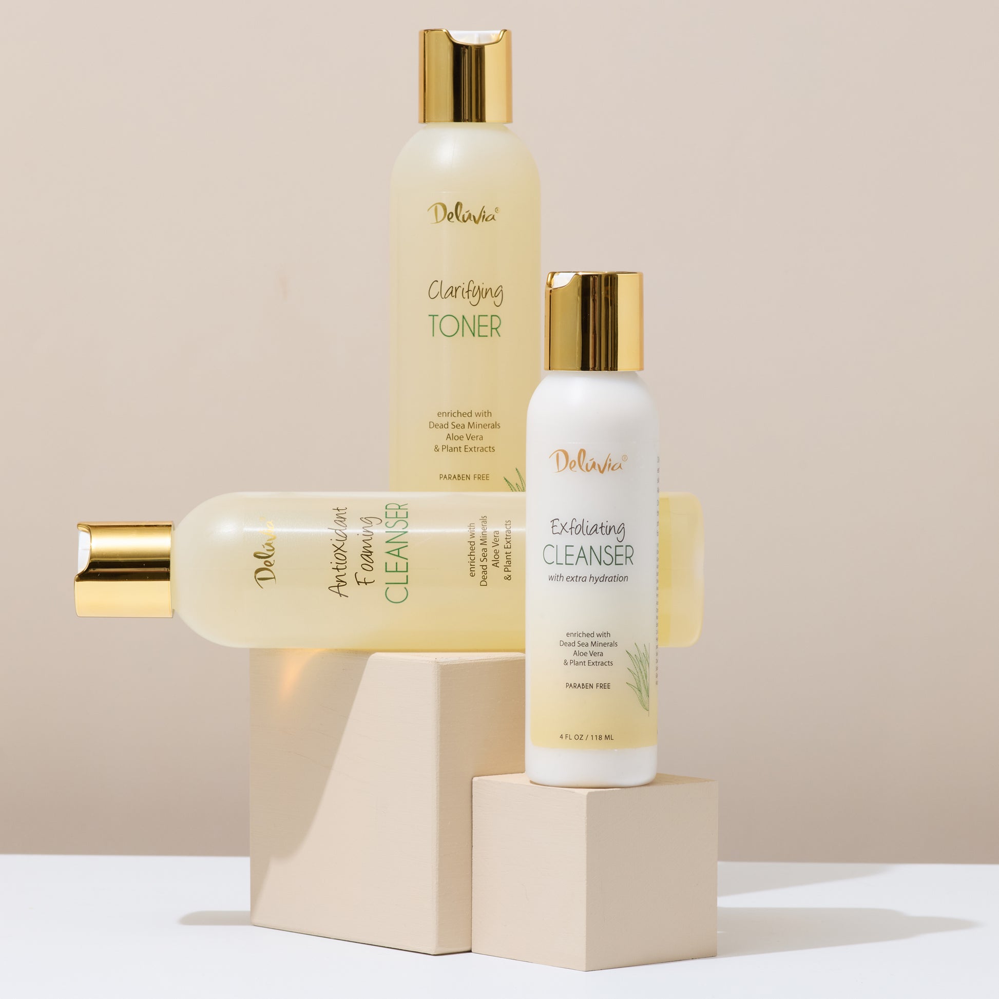 Set of skincare products including toner, cleanser, and exfoliating cleanser on a beige background