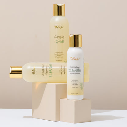 Set of skincare products including toner, cleanser, and exfoliating cleanser on a beige background