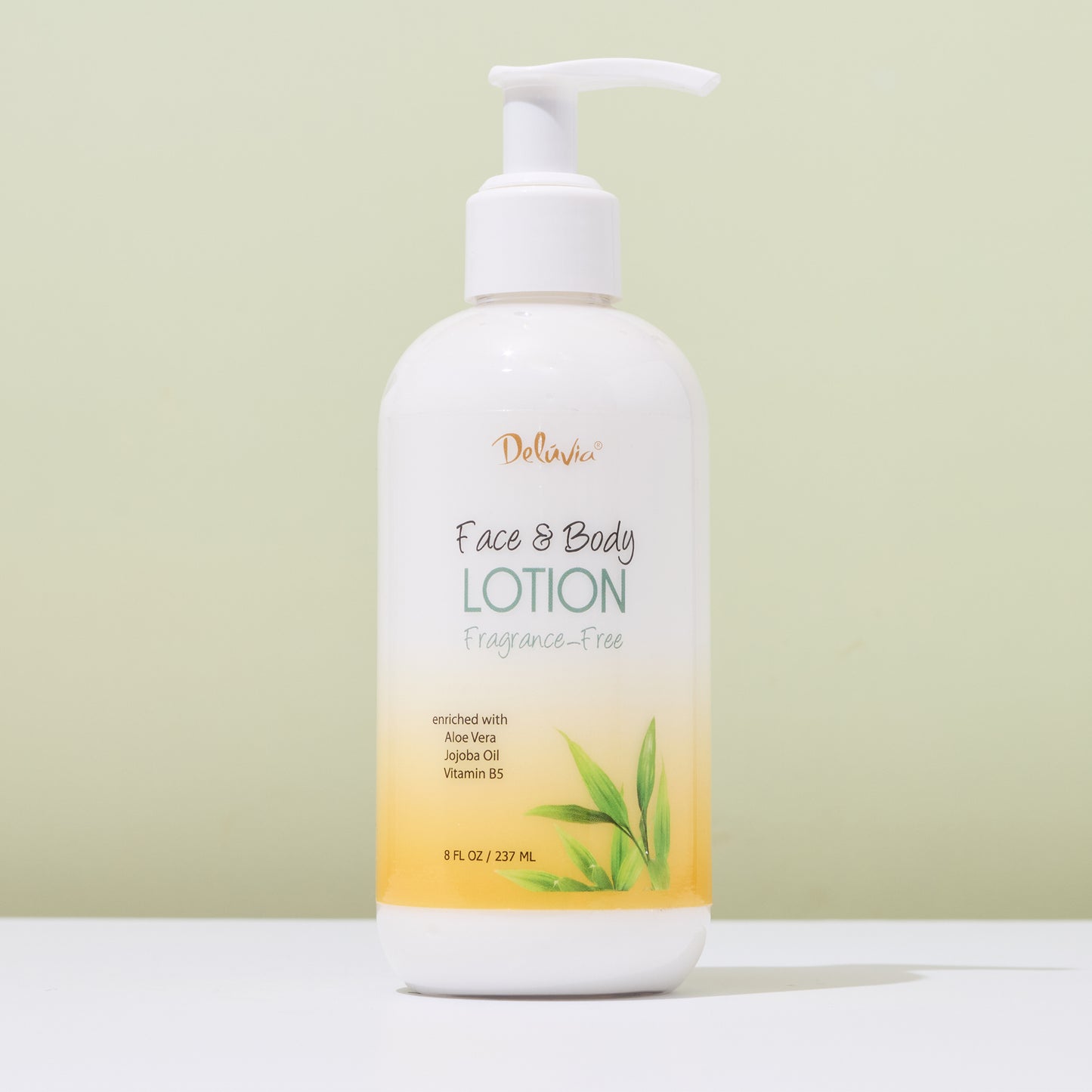 Deluvia Hand & Body Lotion bottle with pump on a light green background