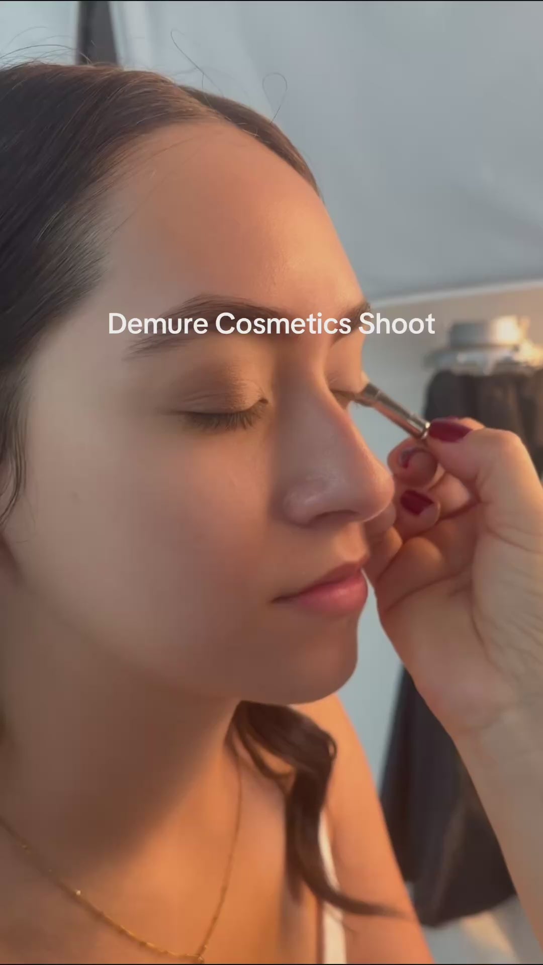 Video of makeup artist applying Demure makeup to a model.