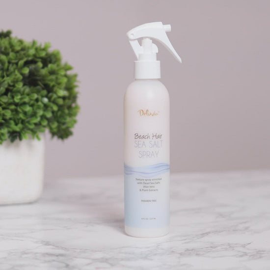 Video clip showing a young brunette spraying her hair with the Deluvia Beach Hair Sea Salt Spray product