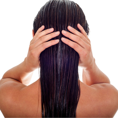  Woman with her hair cascading down her back with conditioning treatment in it.